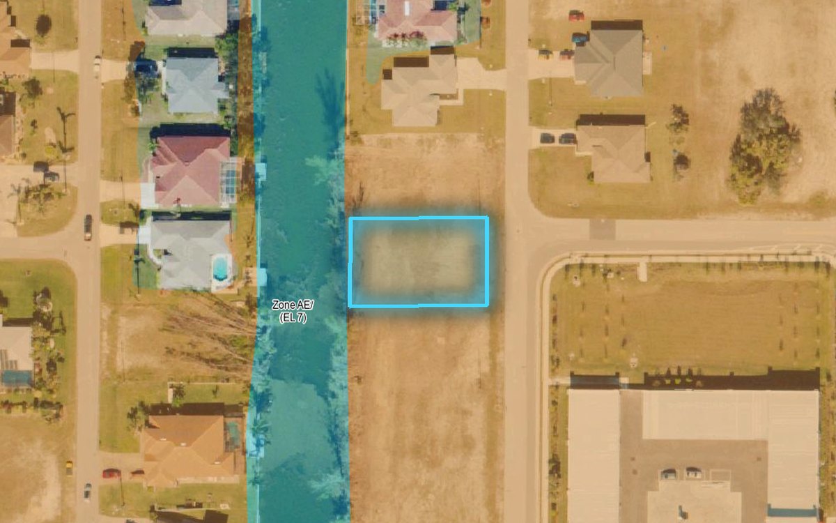 Aerial of a canal lot with FEMA flood zones shaded and the lot outlined